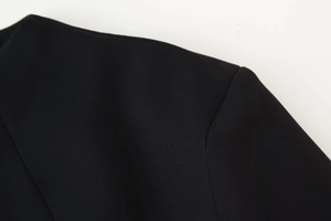 Detailed view of the shoulder stitching and high-quality fabric on this black dress