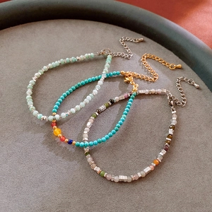 Close-up of three handmade natural stone beaded bracelets with adjustable silver chains