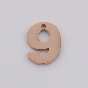 Close-up of number 9 pendant in rose gold finish with mirror polished stainless steel