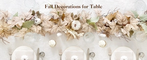 Close-up of fall garland with white pumpkins and maple leaves for autumn table decor