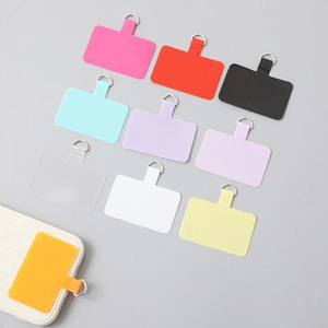 Flat lay of colorful phone tether tabs with metal D-rings in ten vibrant shades