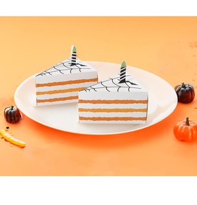 Detail of triangle cake-shaped Halloween candy boxes with spider web and candle decorations