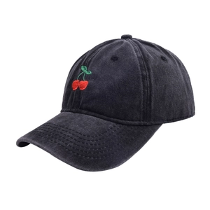 Detail of red cherry embroidery on washed black vintage cotton baseball cap