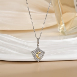 Diamond-encrusted rhombus shield necklace featuring a gold crescent moon pendant