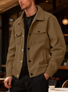 Macro detail of brown corduroy fabric texture and dual chest pockets on men's jacket