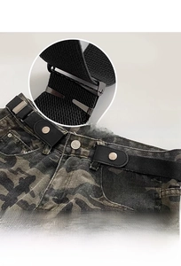 Detail of black elastic adjustable belt with matte metal buckle on camo cargo pants