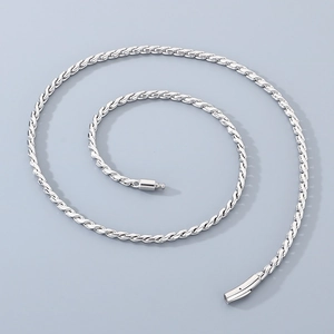 Macro shot of a silver twisted rope chain necklace with a secure lobster clasp closure