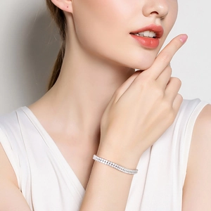 Close-up of double-row tennis bracelet with sparkling zircons on a woman's wrist