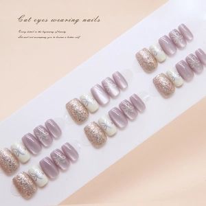 Cat-eye purple and floral press-on nails set on a white display card with soft lighting
