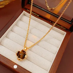 Maillard style gold tiger eye square pendant necklace with intricate braided chain