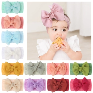 Detail of colorful nylon baby headbands with large soft bows in various pastel shades