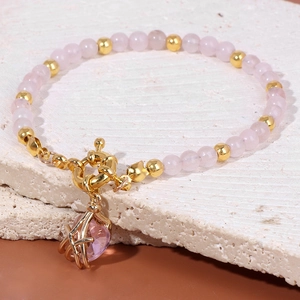 Pink gemstone bead bracelet with golden heart pendant and elegant toggle clasp