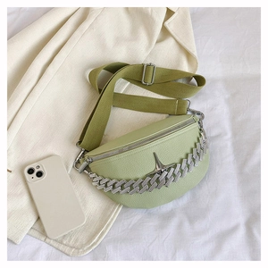 Detail of mint green pebble leather waist bag with silver chain and star ornament
