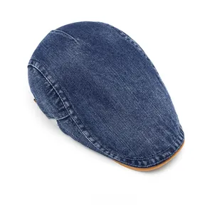 Macro view of high-density washed denim flat cap with leather trim and stitching