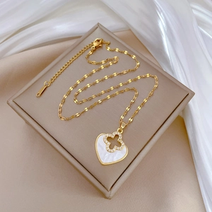 Luxurious gold-plated titanium heart necklace with clover motif and sparkling crystals