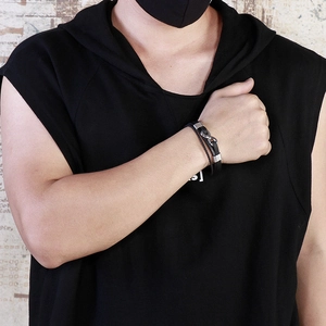 Close-up of men's black leather infinity bracelet with silver-tone metal clasp
