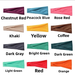 Detail view of 12 colorful wide elastic headbands arranged in a neat grid on white background