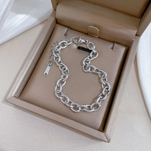 Detailed view of the S925 hallmark on a retro silver chain bracelet in a jewelry box