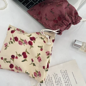 Close-up of floral corduroy drawstring storage bags with elegant vintage rose patterns