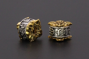 Close-up of retro two-tone alloy beads with embossed Bogu patterns for jewelry making