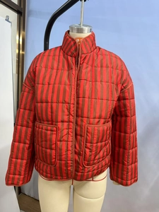 Close-up of a red-brown striped quilted jacket featuring a stand collar and large pockets