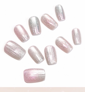 Close-up of aurora pink cat-eye press-on nails with silver shimmer and glossy finish