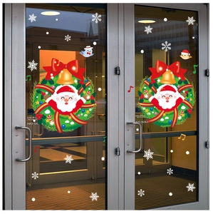 Detail of Christmas window stickers with Santa Claus wreath and snowflakes on glass doors