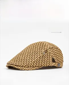 Close-up of coffee brown woven flat cap showing V-shaped texture and SETIROM metal logo
