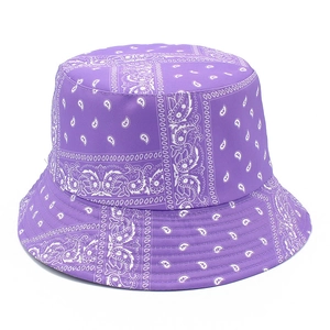 Detail of purple bucket hat with white paisley pattern showing cotton texture and brim