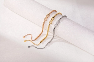 Detailed close-up of three infinity bracelets in rose gold, gold, and silver finishes