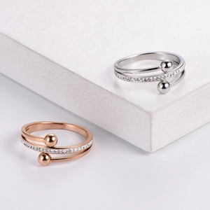 Detail of layered cross ring set with clear crystals and beads in rose gold and silver