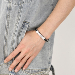 Men's vintage braided stainless steel bracelet with silver buckle on denim background