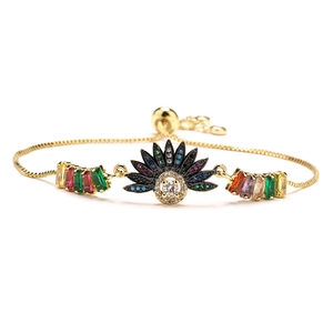 Adjustable 18K gold plated bracelet featuring colorful zirconia butterfly and sunburst charms
