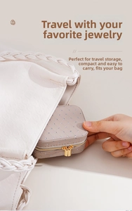 Mini travel jewelry organizer in beige PU leather being placed inside a woven bag