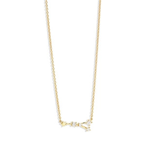 Detailed macro view of a gold-toned constellation pendant with stars and zircon stones