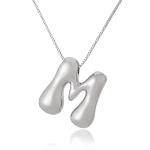 Detail of silver 3D bubble letter M necklace with high-shine polished metallic finish