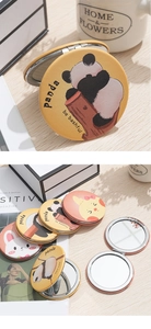 Macro shot of portable double-sided round cartoon makeup mirror with panda and rabbit prints