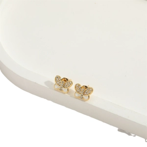 Minimalist gold butterfly earrings with sparkling crystals and white resin details