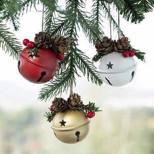 Christmas tree ornaments featuring gold red bells with pine cones and berries decor
