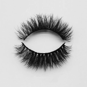 Close-up of dense fluffy black faux mink eyelashes with natural curl on white background