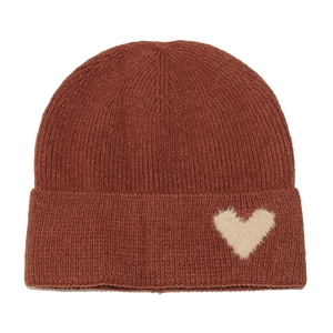 Detail of caramel knit beanie with chunky vertical stripes and plush heart patch accent