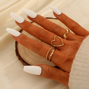 Set of four minimalist gold-plated rings including heart and textured bands for women