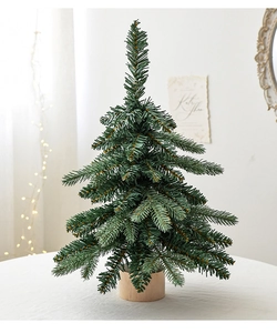 Close-up of mini green PE Christmas tree with natural texture on a round wooden base