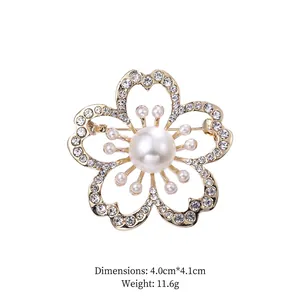 Close-up of gold flower brooch with white rhinestones and pearls, size 4.0cm x 4.1cm