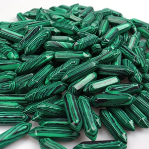 Close-up of natural green malachite crystal points in hexagonal pencil shapes