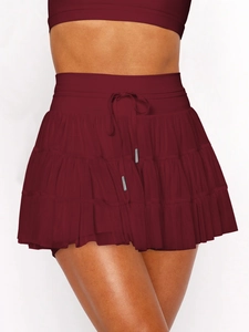 Detail of dark red tiered mesh skirt with layered ruffles and elastic drawstring waist