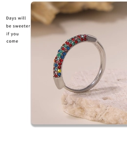 Detailed macro shot of silver ring set with colorful round rhinestones on porous stone
