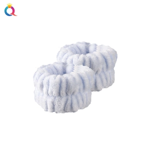 Detail of two blue coral fleece wristbands for face washing with soft striped texture