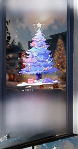 Detailed view of purple Christmas tree window decal with stars and Merry Christmas text