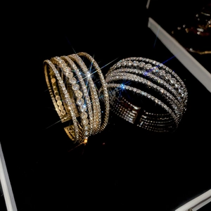 Macro shot of multi-layer geometric open cuff with sparkling rhinestones in a gift box